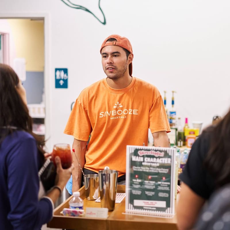 Aldo talks with guests from behind the Sin Booze bar